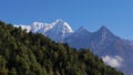 Snow-capped mountain Kusum Kanguru in Hinku Himal east of Namche Bazar, Himalayas, Nepal with forest of coniferous trees. Royalty Free Stock Photo