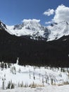 Snow capped mountain peaks against blue sky with puffy white clouds 4. Royalty Free Stock Photo