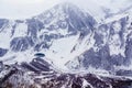 Snow-capped mountain peaks and deep gorges in the area of cross pass, Georgia.  Round lake in the gorge Royalty Free Stock Photo