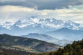 Snow capped mountain peaks in the distance enhance depth perception, emphasizing directional concept