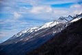 The Snow-Capped Mountains Against A Clear Sky with clouds. Royalty Free Stock Photo
