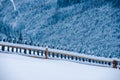 Snow-capped mountains in corpses, snow falls on trees, small village Royalty Free Stock Photo