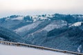 Snow-capped mountains in corpses, snow falls on trees, small village Royalty Free Stock Photo