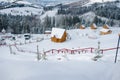 Snow-capped mountains in corpses, snow falls on trees, small village Royalty Free Stock Photo