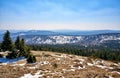 Snow capped mountains with forest of conifers. Blurred mountains on the horizon Royalty Free Stock Photo