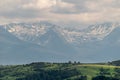 Snow capped mountains with hills in the foreground Royalty Free Stock Photo