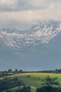 Snow capped mountains with hills in the foreground Royalty Free Stock Photo