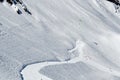 Snow-capped mountains, snowdrifts, blue sky in the Caucasian ski resort.Hang glider flies in a mountain gorge.