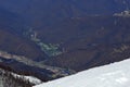 Snow-capped mountains, snowdrifts, blue sky in the Caucasian ski resort.Hang glider flies in a mountain gorge.