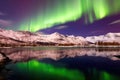 snow-capped mountains under the glowing aurora borealis