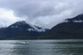 Snow capped mountains at the water on a cloudy day Royalty Free Stock Photo