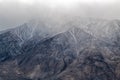 Snow capped mountaintops covered in clouds near Bishop, California, USA