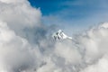 Snowcapped mountain peak emerges from the clouds Royalty Free Stock Photo