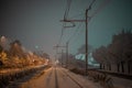 Snow capped railway track or railroad covered with snow during night time