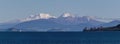 Snow capped volcanoes over lake Taupo Royalty Free Stock Photo