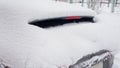 Snow on cars after snowfall. Winter urban scene. rear window Royalty Free Stock Photo