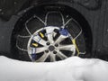 Snow chain on car tyre in snow Royalty Free Stock Photo