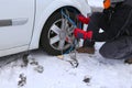 Snow chains in the car tyre in winter on snow