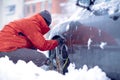 Snow chains on the wheels of car.Man preparing car for travelling at winter day Royalty Free Stock Photo