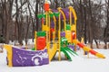 Empty snow children playground in the park in winter time