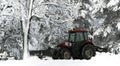 Snow cleaning tractor clears paths