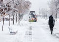 Snow clearing. Tractor clears road, way after heavy snowfall. Tractor cleaning the road from the snow. Excavator cleans the street Royalty Free Stock Photo