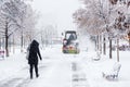 Snow clearing. Tractor clears road, way after heavy snowfall. Tractor cleaning the road from the snow. Excavator cleans the street Royalty Free Stock Photo