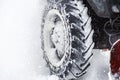 Snow clearing. Tractor clears the way after heavy snowfall. close up of tires. Snowblower grader clears snow covered road Royalty Free Stock Photo