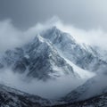 Snow cloaked mountain stands tall beneath a moody, overcast sky