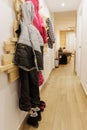 Snow clothes hanging on a hanger on the wall and boots on the floor in the entrance hall of the holiday apartment