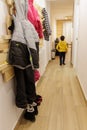 Snow clothes hanging on a hanger on the wall and boots on the floor in the entrance hall of the holiday apartment