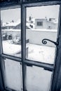 Snow coverd garden seen through a window Royalty Free Stock Photo