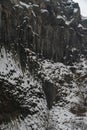 Snow-covered basalt columns form dramatic vertical patterns at the Symphony of Stones, dark volcanic rock contrasts with Royalty Free Stock Photo