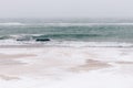 Snow-covered beach during a snowfall, seascape