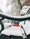 Snow-covered bench with a red toy car carrying a Christmas tree on a roof Royalty Free Stock Photo