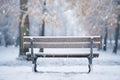 Snow-covered bench in a snowy park. View from back Royalty Free Stock Photo