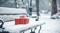 Snow-covered bench with wrapped gift and thermos . Royalty Free Stock Photo
