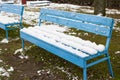 Snow covered benches in the yard closeup Royalty Free Stock Photo