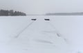 Snow-covered berth on a frozen lake