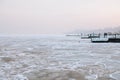 Snow-covered Black sea shore at sunrise.Snow, ice, frozen water. Soft sunlight. Royalty Free Stock Photo