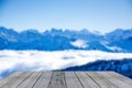 Wooden display shelf table top against blurred blue winter mountain panorama, snow covered blue mountain layers Royalty Free Stock Photo