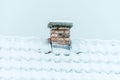 Snow-covered brick chimney on rooftop against pale winter sky Royalty Free Stock Photo
