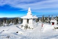 Snow-covered Buddhist stupa on mountaintop