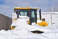 Bulldozer buried in the deep snow