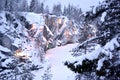 Snow-covered canyon with forest lighting, winter landscape
