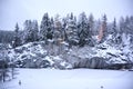 Snow-covered canyon with forest lighting, winter landscape