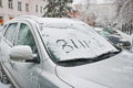 Snow covered car. In the snow, the finger says `Winter` Royalty Free Stock Photo