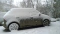 Snow covered car. Painting auto in winter concept. Protection of vehicle against corrosion, salt, reagents. Danger by not clearing