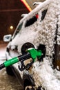 Snow covered car refueling at the gas station at night Royalty Free Stock Photo