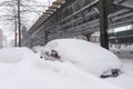 Snow Covered Cars along a Street and Below Elevated Subway Tracks in Astoria Queens New York during Winter Royalty Free Stock Photo